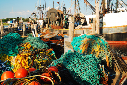 Commercial Fishing Vessels with their nets all tangled, are docked in Montauk Harbor, Long Island, New York