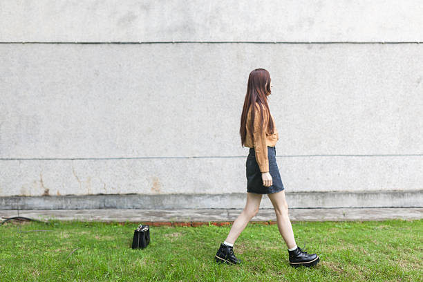 istock asian young  girl walking alone the wall 639876972