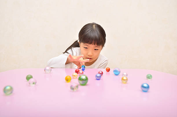 a pretty little girl singing with a toy microphone with tousled hair