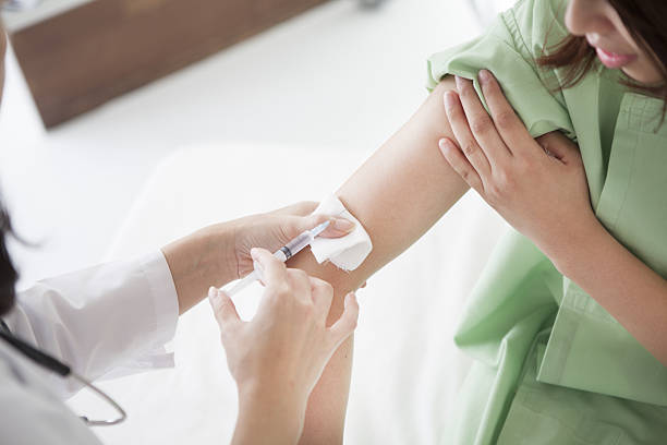 istock Doctor injecting a patient at a hospital 639878468