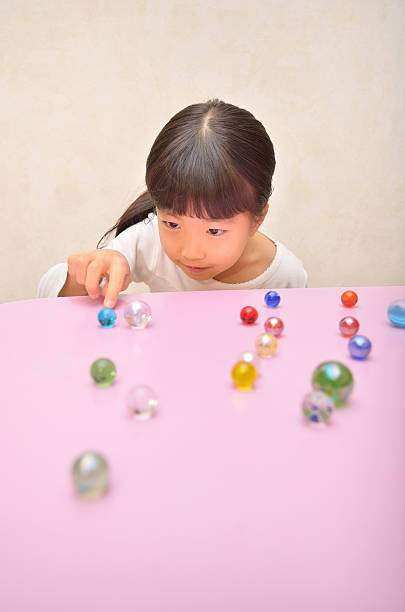 Lovely and cute cheerful child playing with plastic dinosaur toys in bedroom.