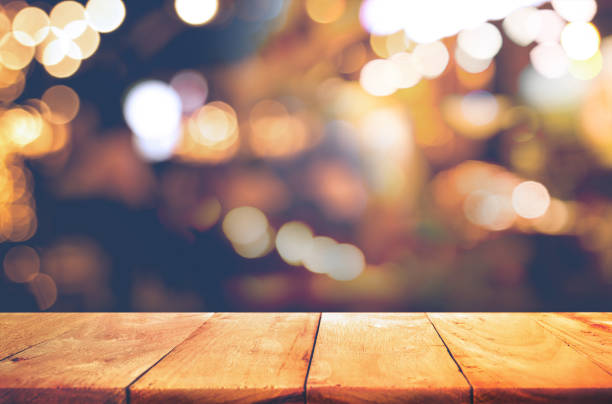 Wood  table top with  blurred light gold bokeh abstract background