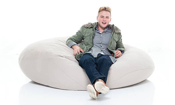 istock Smiling man lying on bean bag 639880146