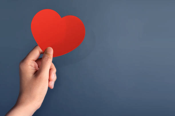 istock Red Heart Paper cuts in Female Hand 639880276