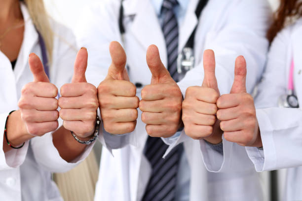 istock Three medicine doctors show OK sign with thumb up 639880422