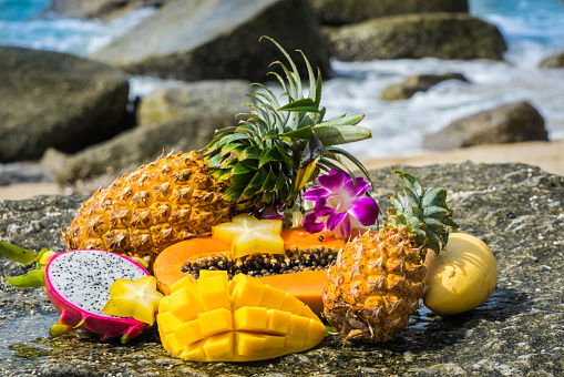 Tropical fruits on the rock close up