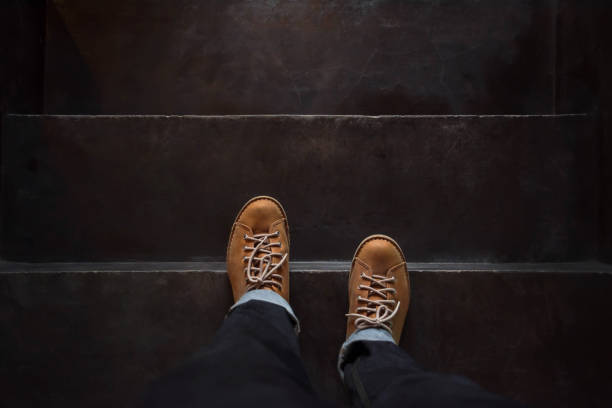 istock Top view, Male Steps over Black Concrete Stair 639881772