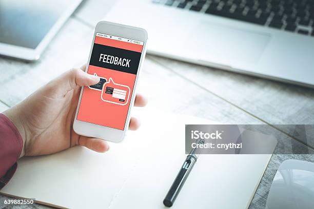 Smartphone In Hand And Showing Feedback Concept On Screen Stock Photo - Download Image Now