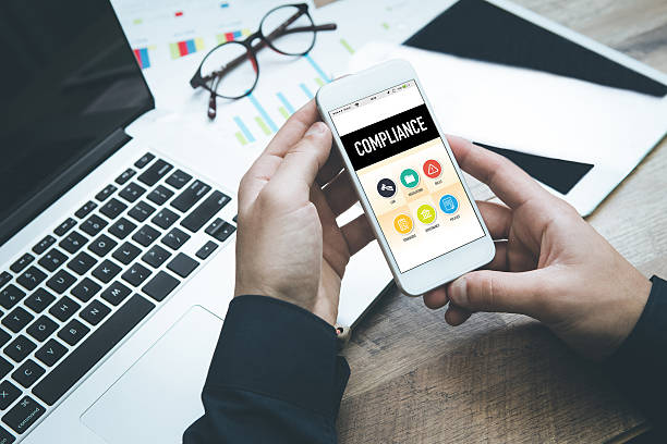 istock Smartphone in hand and showing Compliance concept on screen 639882630