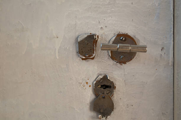istock Keyhole with cap on the painted metallic door. 639883878