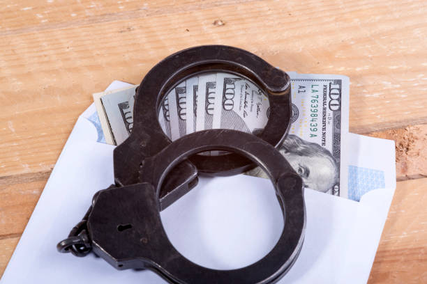 istock Handcuffs and dollar bills 639883934