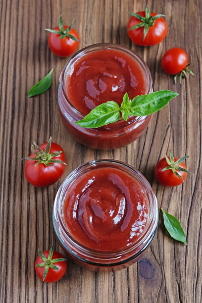 istock Tomato sauce and basil in glass jars 639886916