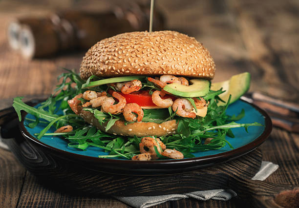 istock Burger with grilled prawns on the plate 639887800