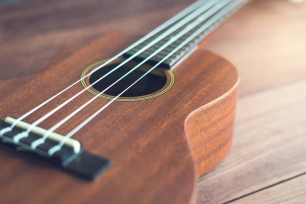 istock Ukulele guitar on wooden table 639887926