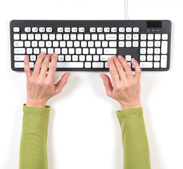 istock Hands in green jacket and grey keyboard 639888596