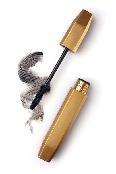 Golden brush of mascara and paint strokes Golden brush of mascara and paint strokes isolated on white background woman mascara smudged stock pictures, royalty-free photos & images