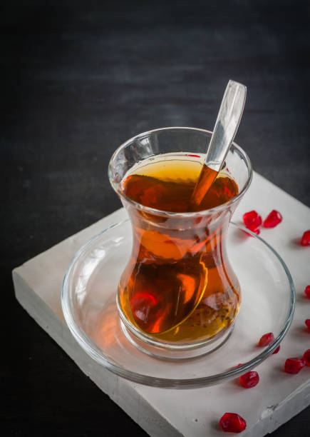 istock Transparent cup of thin glass and black tea. Spoon. 639890210