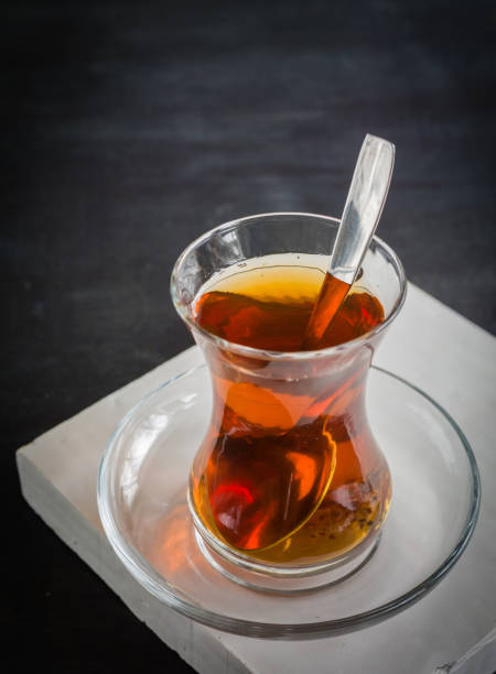 istock Transparent cup of thin glass and black tea. Spoon. 639890220