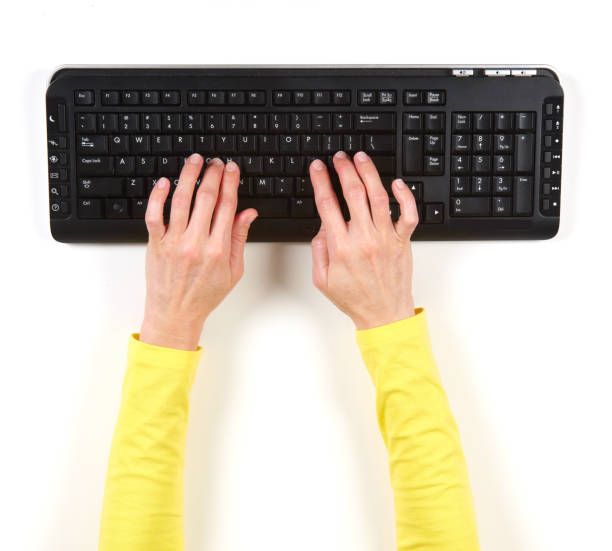 istock Hands in yellow jacket and black keyboard 639892088