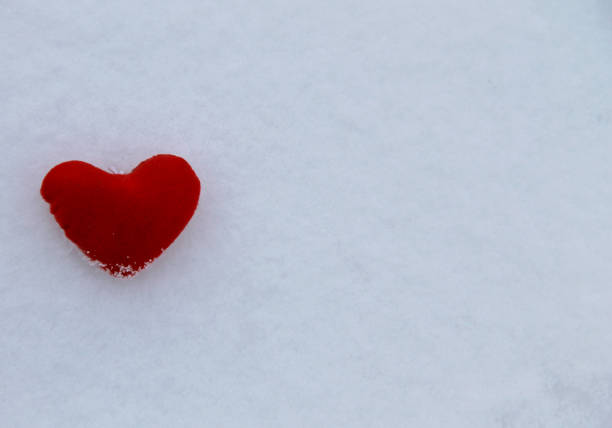 Red heart on the white snow