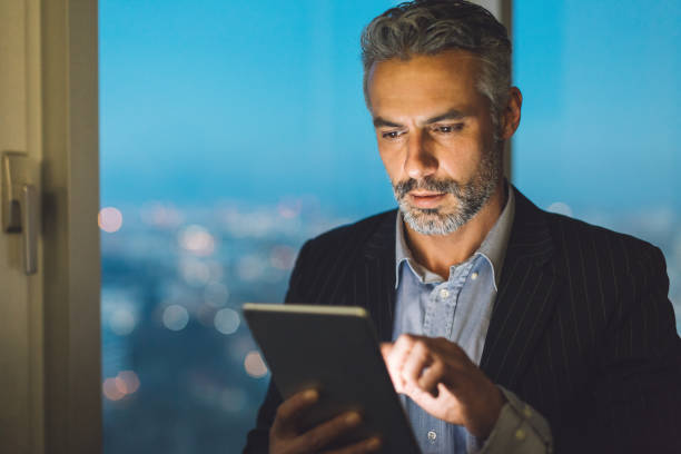istock Mature man with digital tablet in the evening 639895760