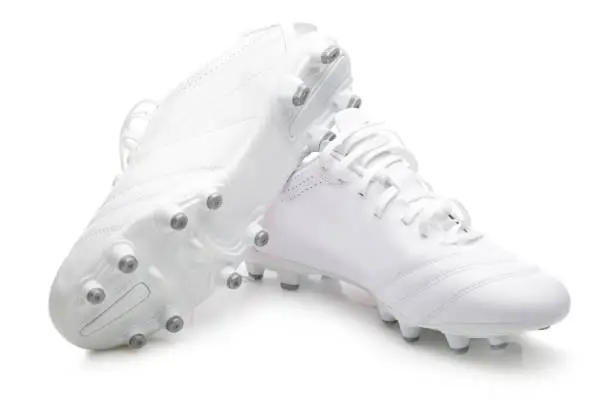 White pair of soccer shoes on white background