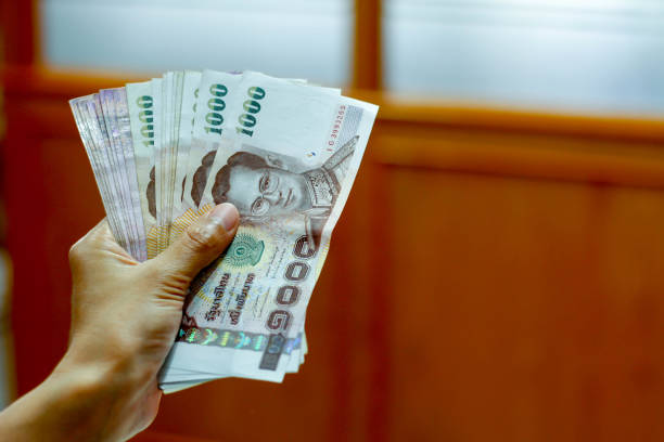 istock Thai money in hand 639897742