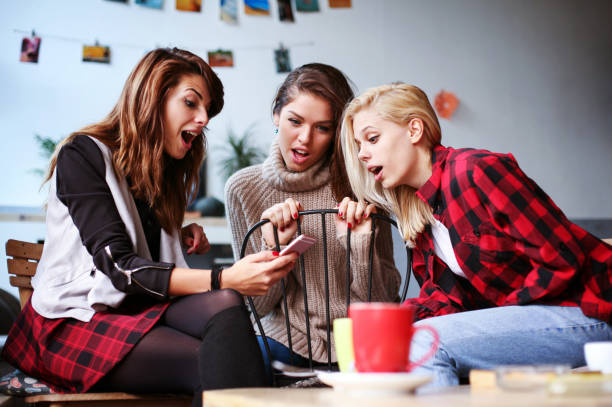 istock Best friends in a cafe using phone. 639897938