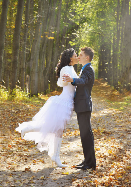 istock Bride and groom walking in autumn pine forest 639898314
