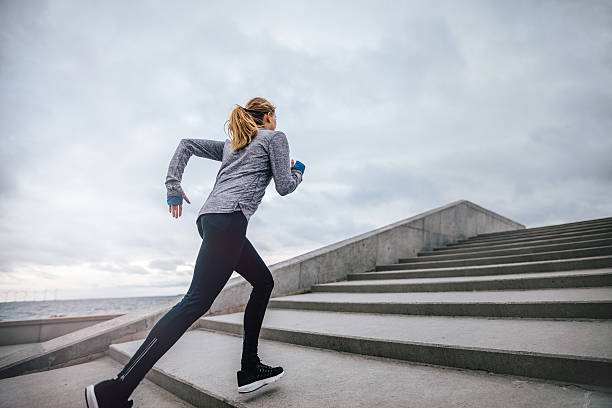 istock Fit young woman running on steps 639900160