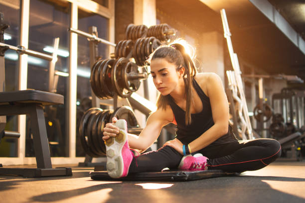 istock Young woman stretching legs in gym. 639901264