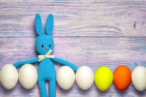 istock Amigurumi toy easter bunny with white and colorful eggs 639902710
