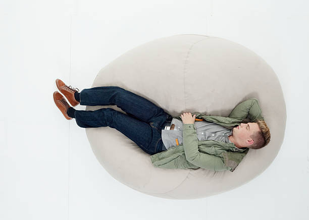 istock Above view of man lying on bean bag 639903548