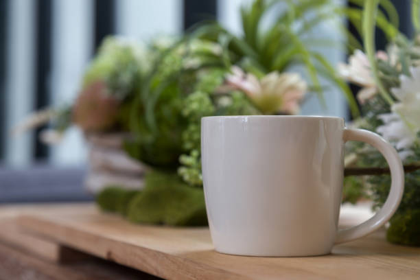 istock white coffee mug on wooden table in coffee shop 639904432