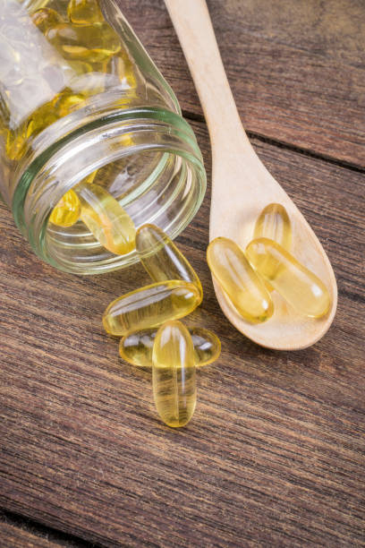 istock fish oil capsule on wooden 639904484