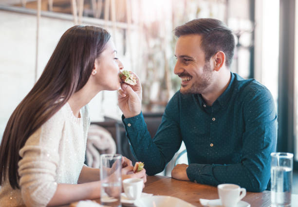 istock Beautiful young couple sitting in a cafe, having breakfast. Love 639906724