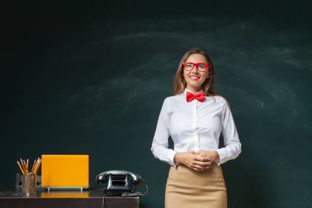 istock Young woman in front of blackboard 639907364