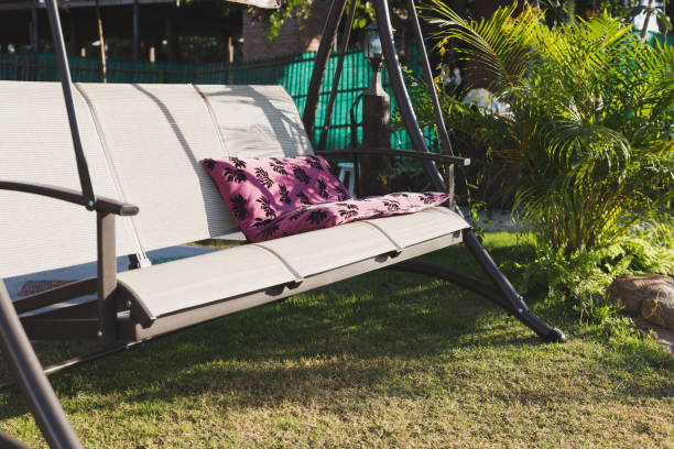 istock comfortable swinging bench in the garden. 639909328