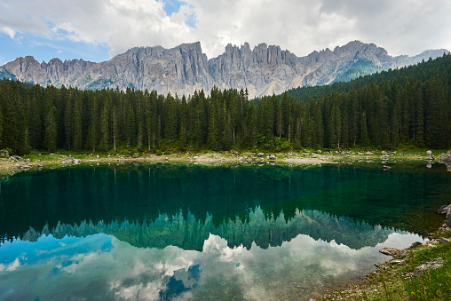 The Latemar mountain range mirroring into Carezza Lake. Nova Levante. Bolzano. Trentino-Alto Adige. Italy.
