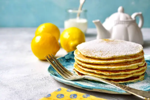 Lemon pancakes with poppy seed on a blue plate.Vintage style.