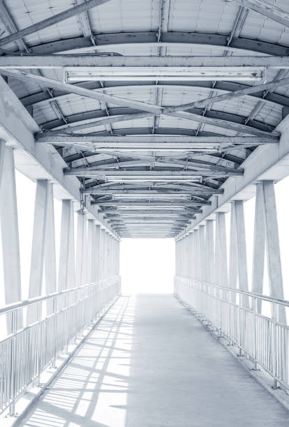 istock Light from the way out of modern metal structure bridge 639915406