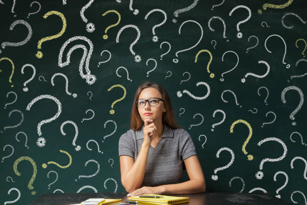 istock Businesswoman and question mark on blackboard 639916348
