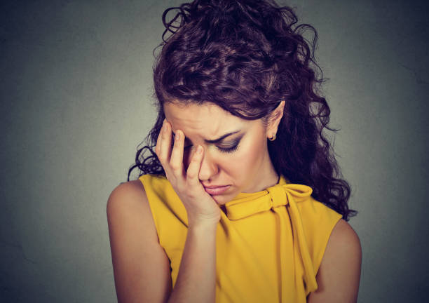 istock depressed sad woman leaning head on hand 639916554
