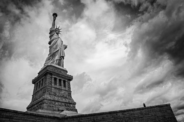 istock Generic lone figure looking at Statue of Liberty 639917326
