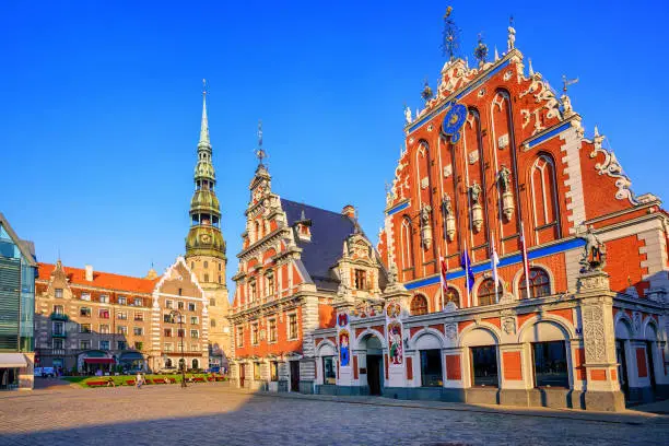 City Hall Square with House of the Blackheads and Saint Peter church in Old Town of Riga in sunset light, Latvia