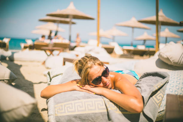 istock Beautiful woman sunbathing relaxing on a beach 639920168
