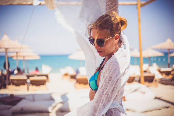 istock Happy woman in bikini posing on beach 639920462