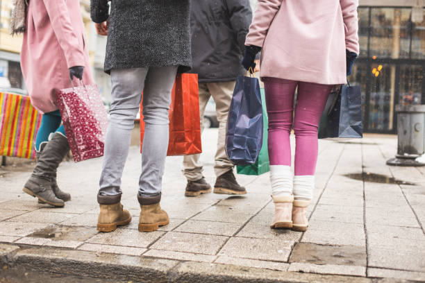istock People carrying shopping bags, low section 639924570