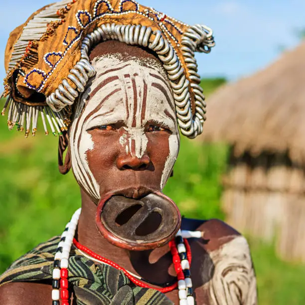 Woman from Mursi tribe with face paint. Mursi tribe are probably the last groups in Africa amongst whom it is still the norm for women to wear large pottery or wooden discs or ‘plates’ in their lower lips.http://bhphoto.pl/IS/ethiopia_380.jpg
