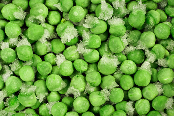 Close-up of frozen green peas with ice crystals